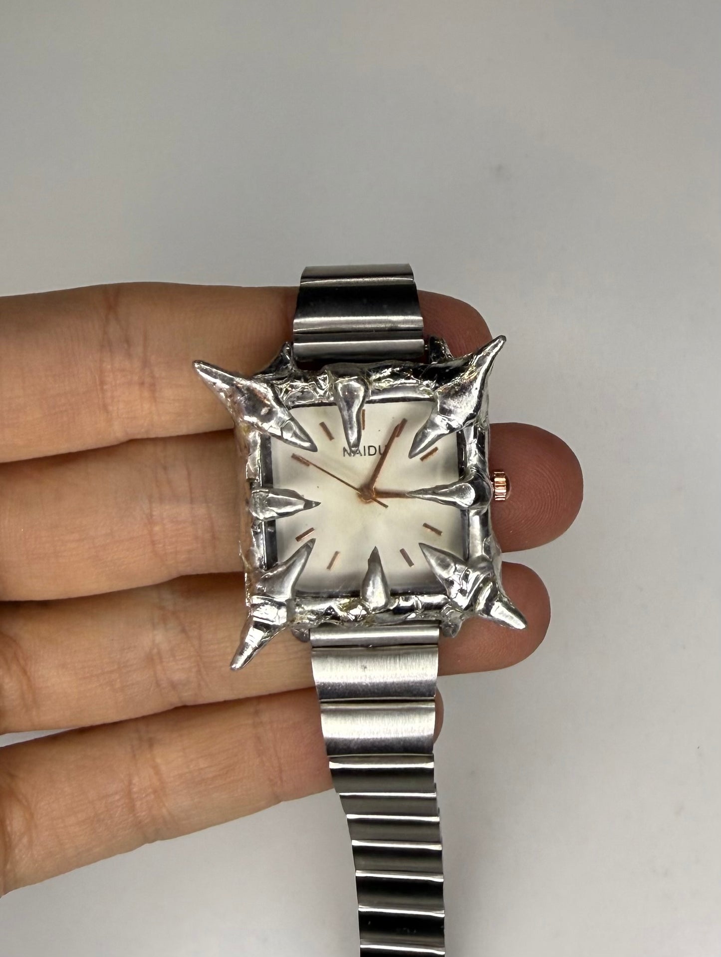 White spiked watch