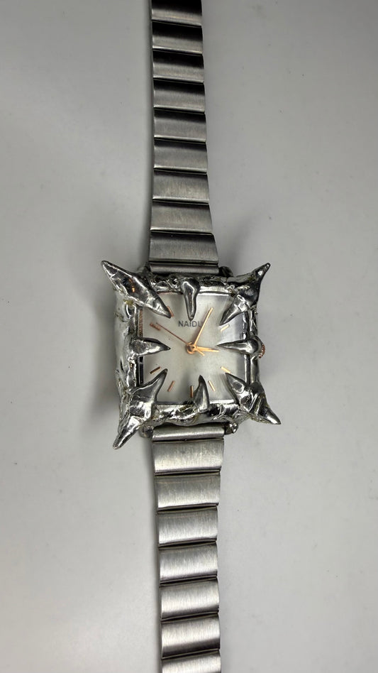 White spiked watch