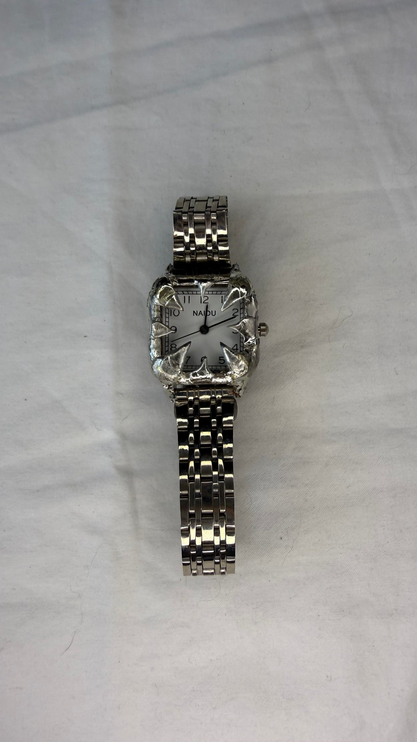 White spiked watch