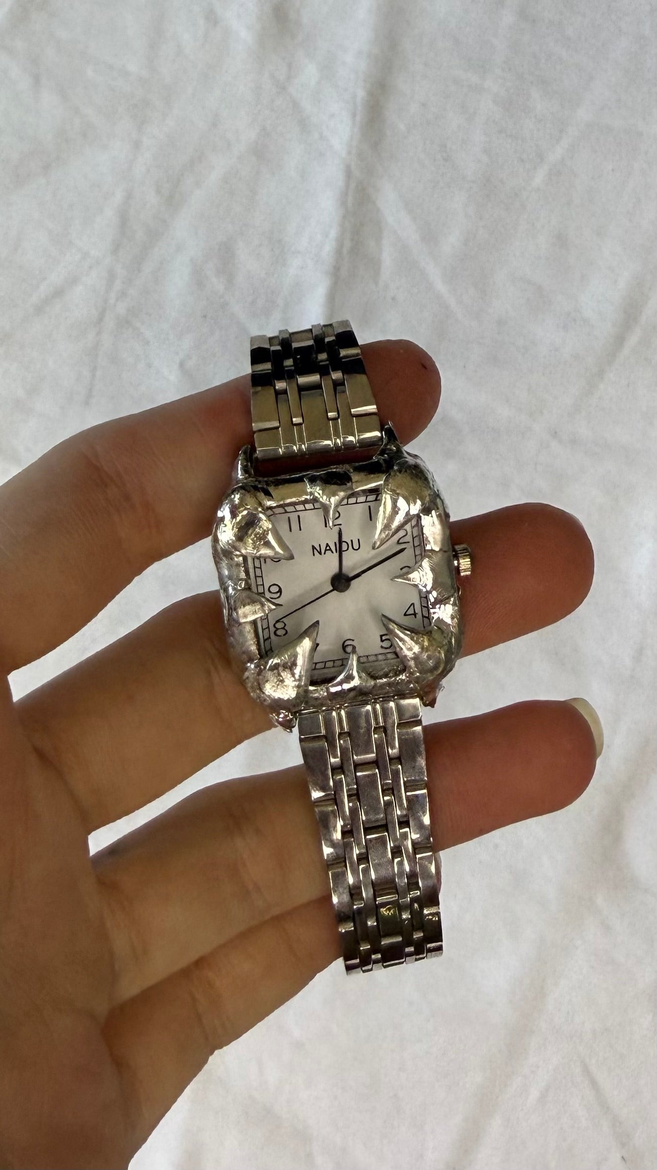 White spiked watch