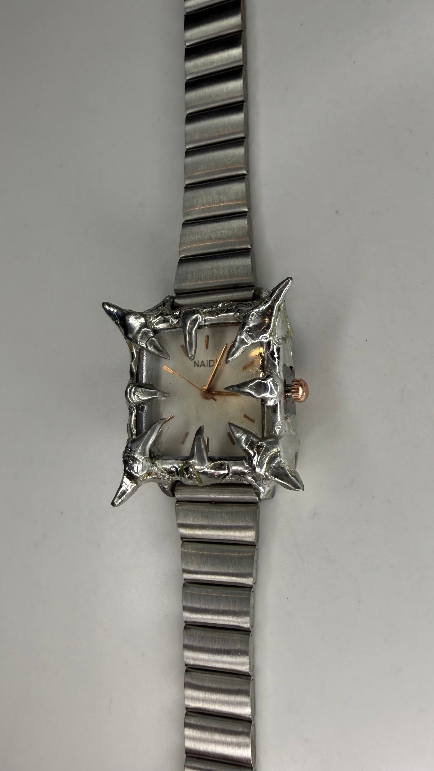 White spiked watch