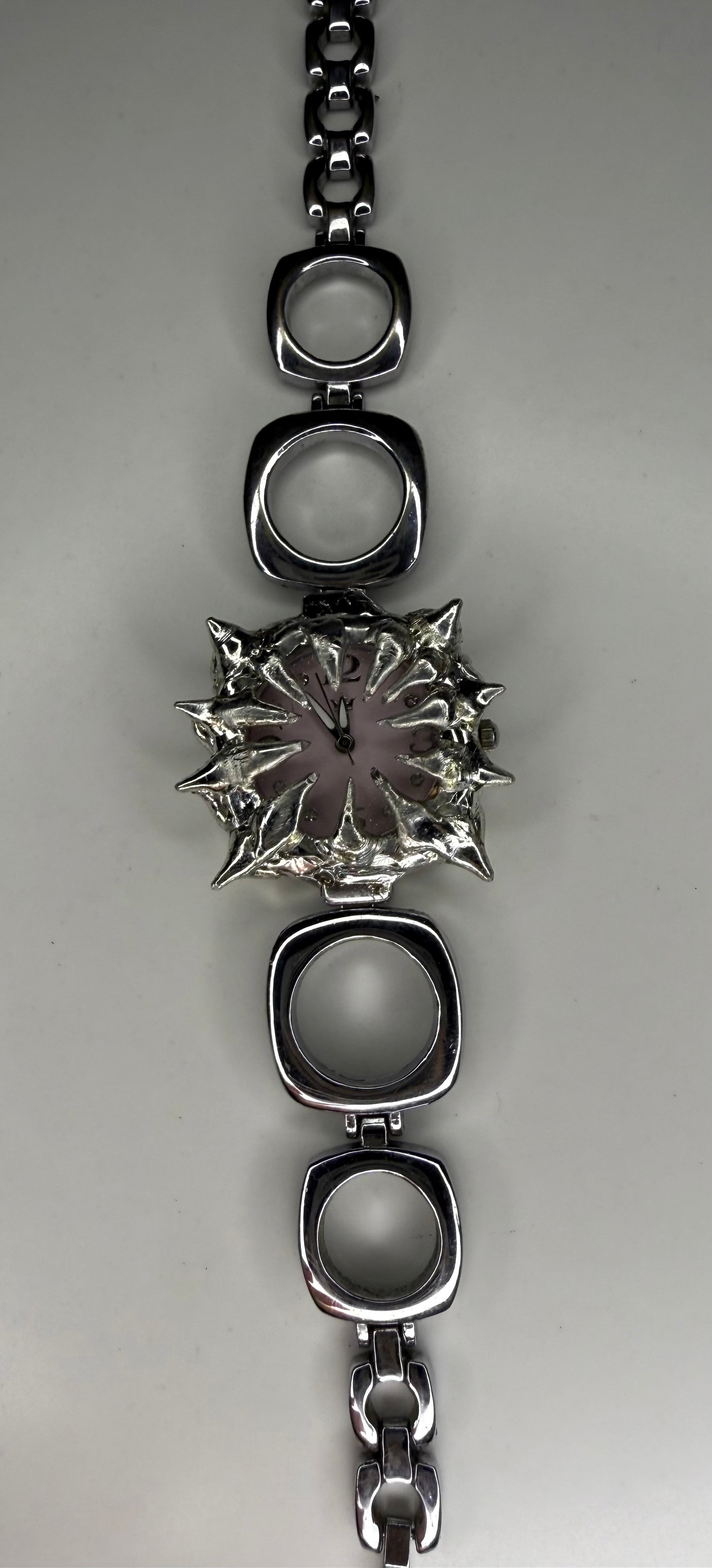Pink spiked oval band watch