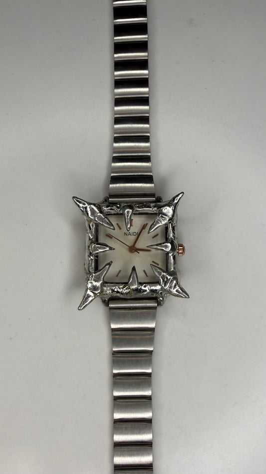 White spiked watch