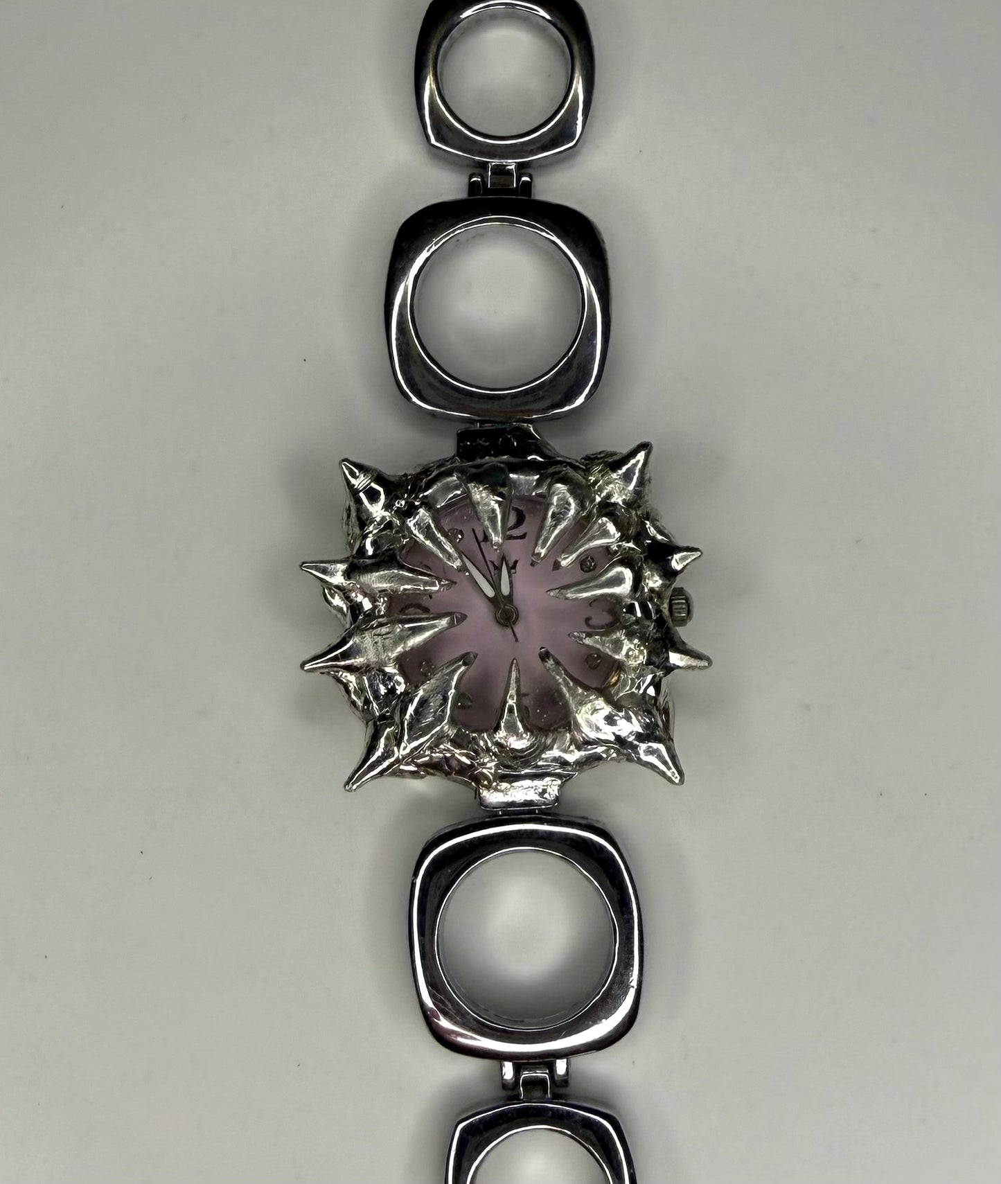 Pink spiked oval band watch